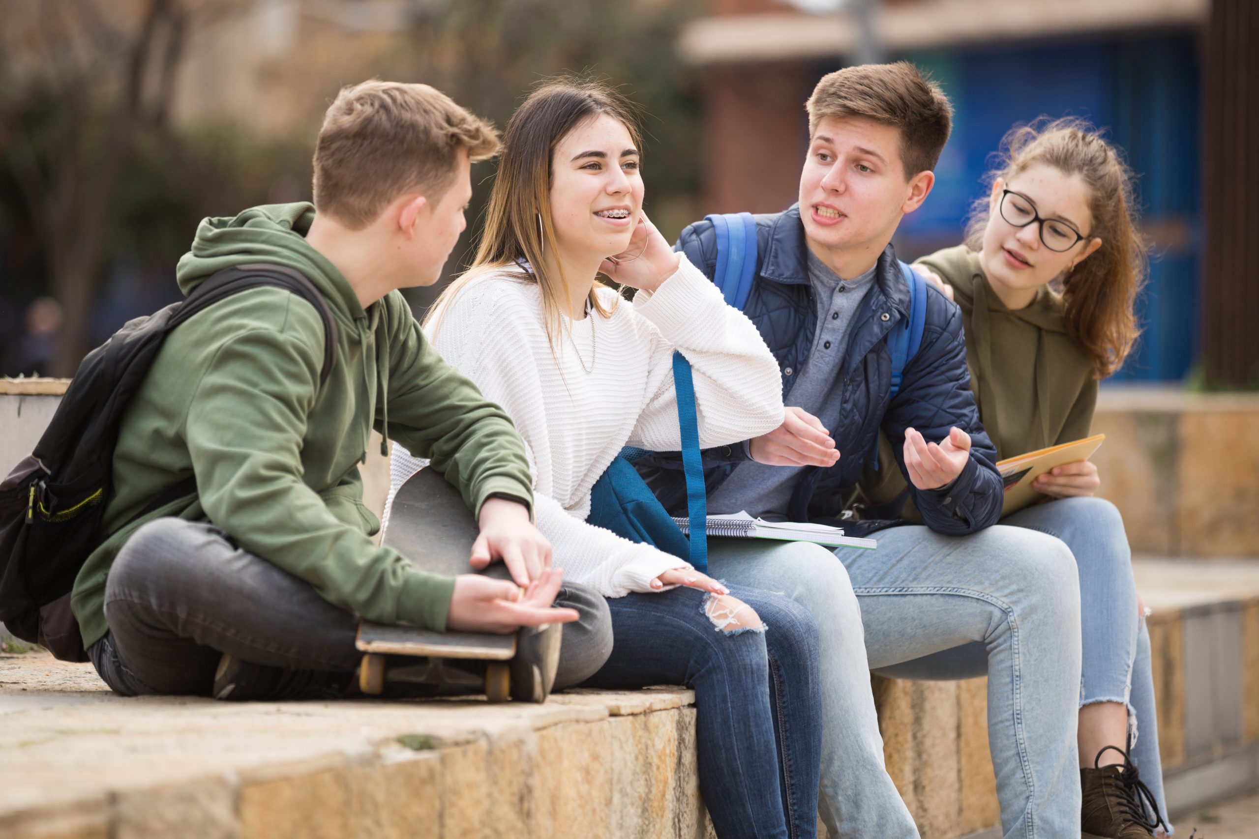 Group of positive teenagers having fun together